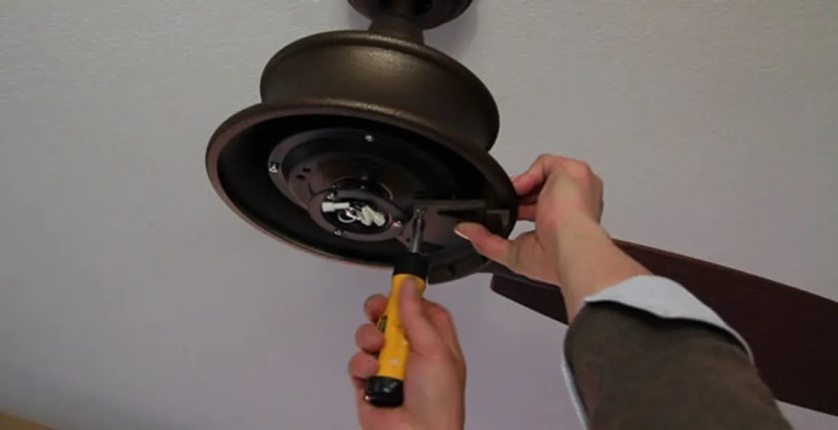 Electrician installing ceiling fan mounting bracket and fixture in Mountain View, CA