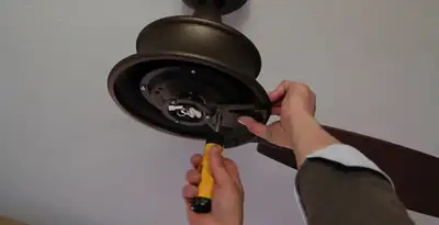 Electrician installing ceiling fan mounting bracket and fixture in Mountain View, CA