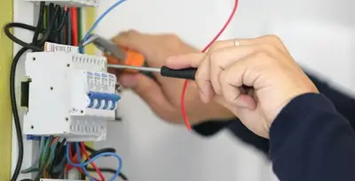 Electrician installing and adjusting circuit breakers in an electrical panel in Mountain View, CA