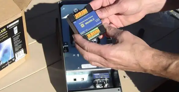 Electrician installing whole home surge protection unit inside main electrical panel in Mountain View, CA