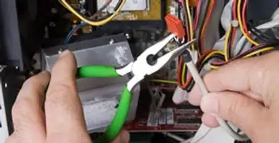 Licensed electrical contractor performing electrical repair with tools in Cupertino, CA