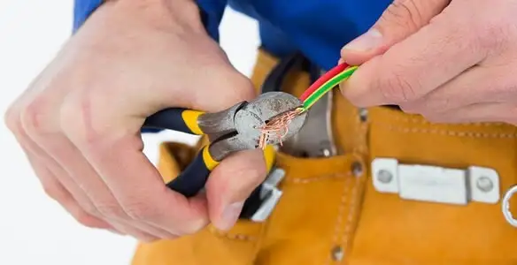 licensed electrician securing electrical wiring with professional tools during service work in Mountain View, CA