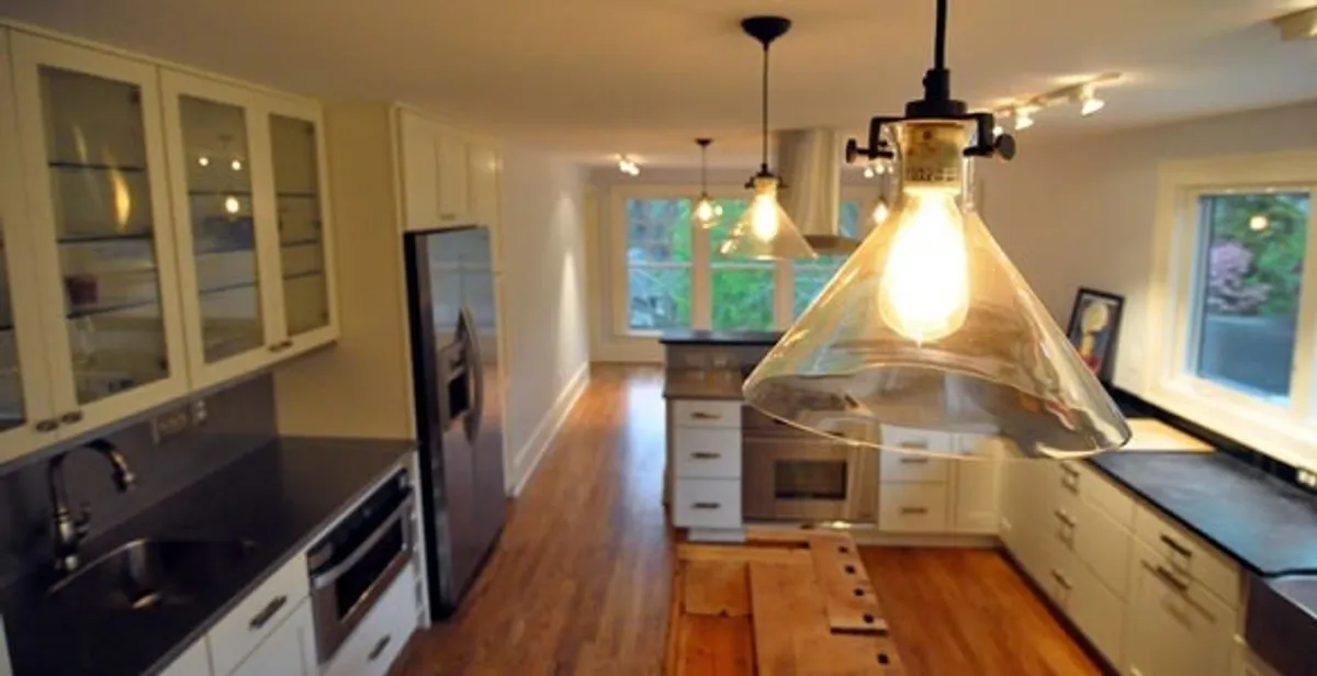 Residential electrician installing modern indoor light fixture in a home in Mountain View, CA